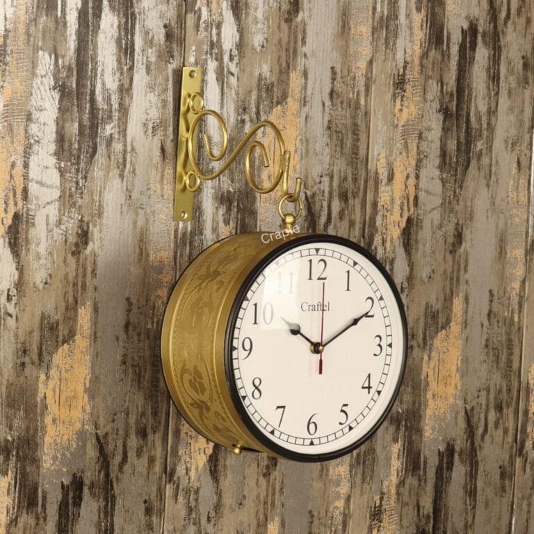 Vintage double-sided station clock with an embossed golden casing, hanging from a decorative wall bracket.