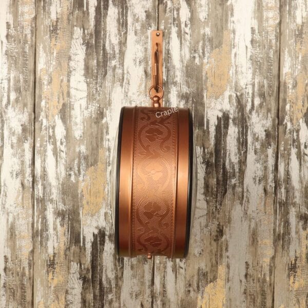 Detailed side profile of the station clock, showcasing the intricate embossed pattern on the brass-coated case.