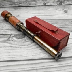 The Dollond London replica telescope fully extended to show its multiple brass sections and the eyepiece.