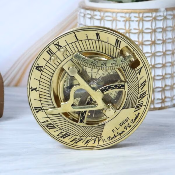 Angled shot of the vintage-style brass sundial compass, highlighting the intricate engravings and shiny finish.