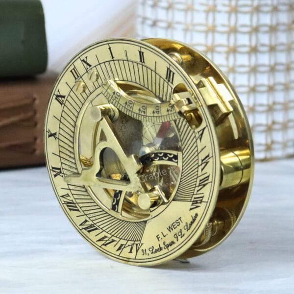Side profile of the round brass sundial compass, showing the depth of the casing and the folded gnomon.