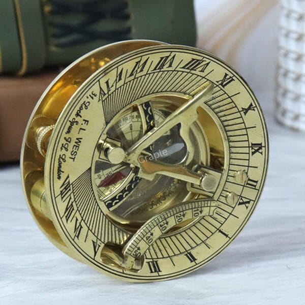 Three-quarter view of the F.L. West pocket sundial compass, focusing on the adjustable latitude arc.