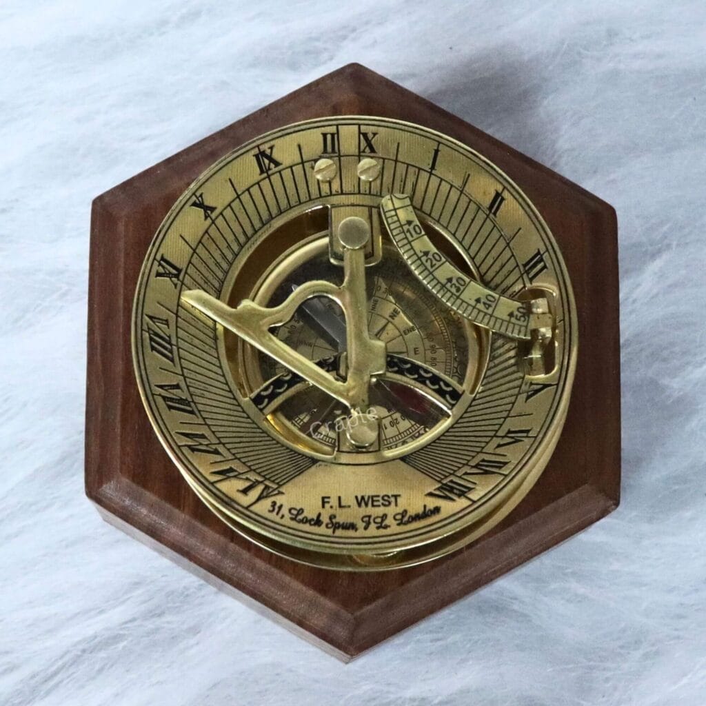 Polished brass F.L. West London sundial compass presented on a handsome hexagonal wooden display base.