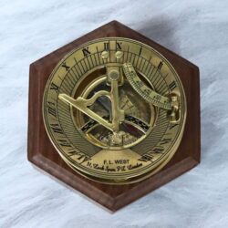 Polished brass F.L. West London sundial compass presented on a handsome hexagonal wooden display base.