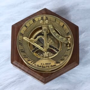 Polished brass F.L. West London sundial compass presented on a handsome hexagonal wooden display base.