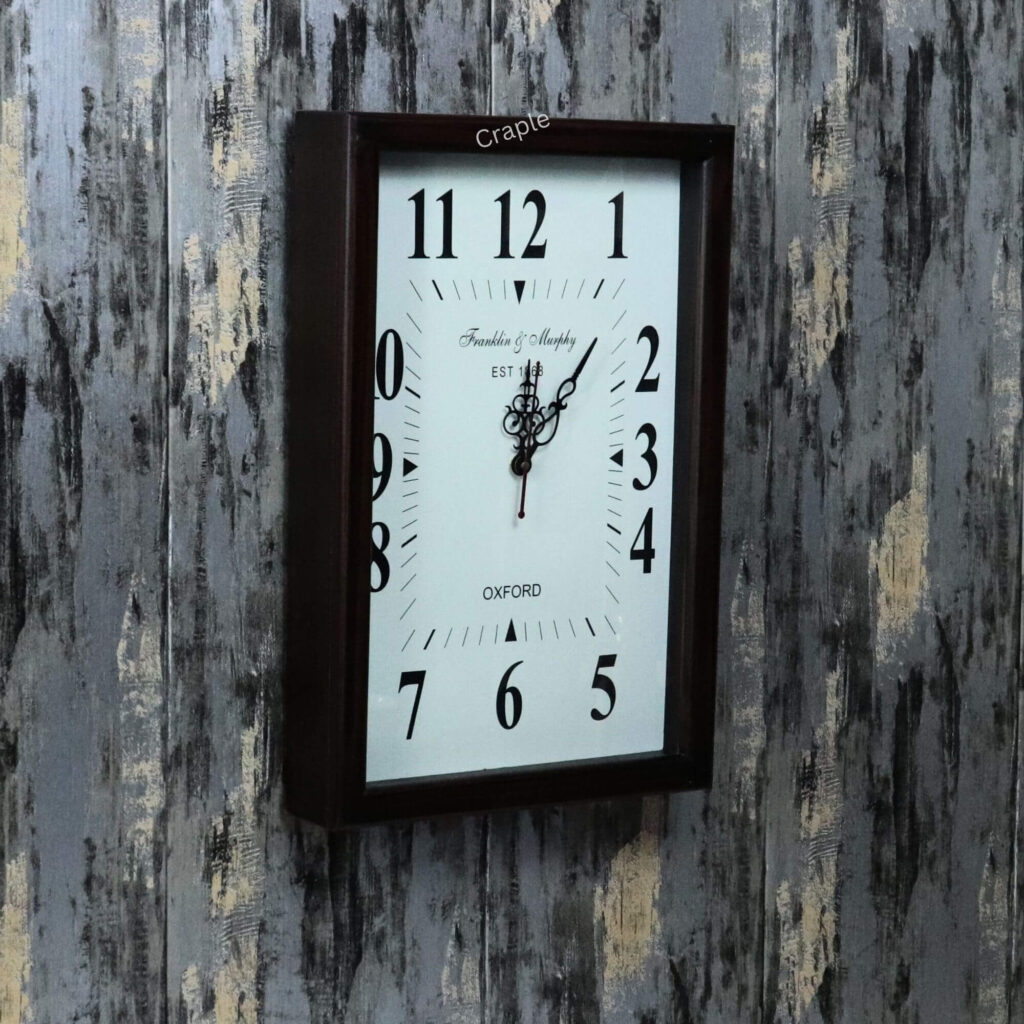 Vintage-style rectangular wall clock in a teak-polished wooden frame, shown at an angle to display its depth.