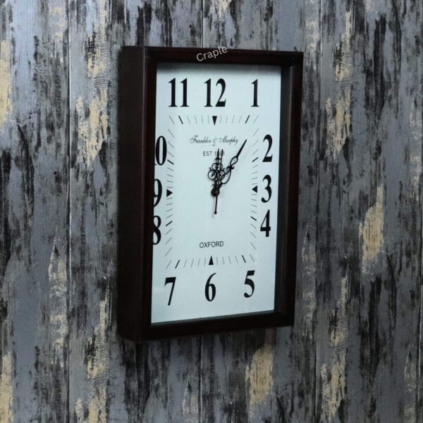 Vintage-style rectangular wall clock in a teak-polished wooden frame, shown at an angle to display its depth.