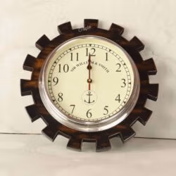 Industrial gear-shaped wooden wall clock with a polished aluminum bezel and a nautical-themed cream dial.