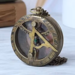 Angled view of the vintage-style brass pocket sundial, highlighting its pocket watch design and attached chain.