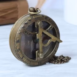 Side profile of the round Gilbert & Sons sundial compass, showing the depth of the casing and the fob chain.