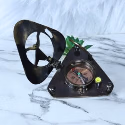 The triangular sundial compass opened to reveal the functional magnetic compass, needle, and integrated bubble level.