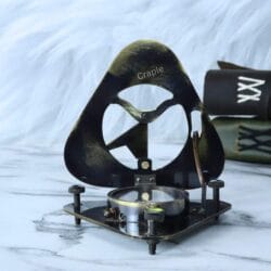 Side profile of the open brass sundial compass, highlighting the three adjustable screw legs for leveling.