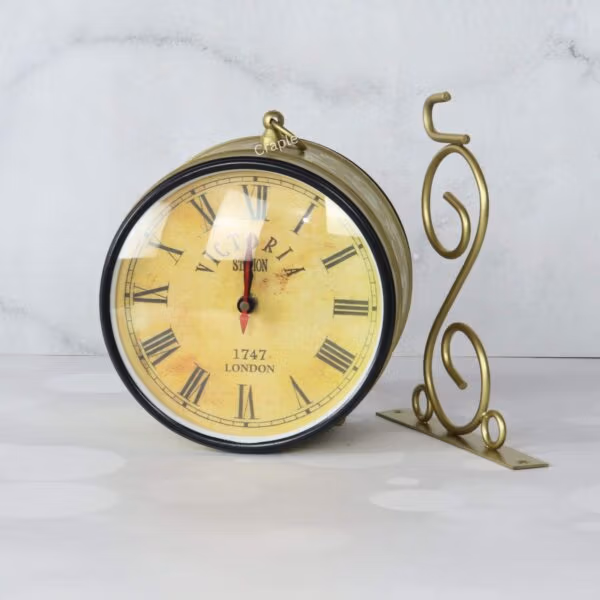 Double-sided station clock with a golden finish and its ornate scroll bracket shown side-by-side.