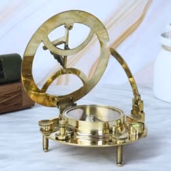 Side view of the adjustable brass sundial compass in its open position, showing the raised gnomon and hour ring.