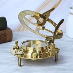 The adjustable brass sundial in an open position, showing a close-up of the integrated liquid-damped magnetic compass.