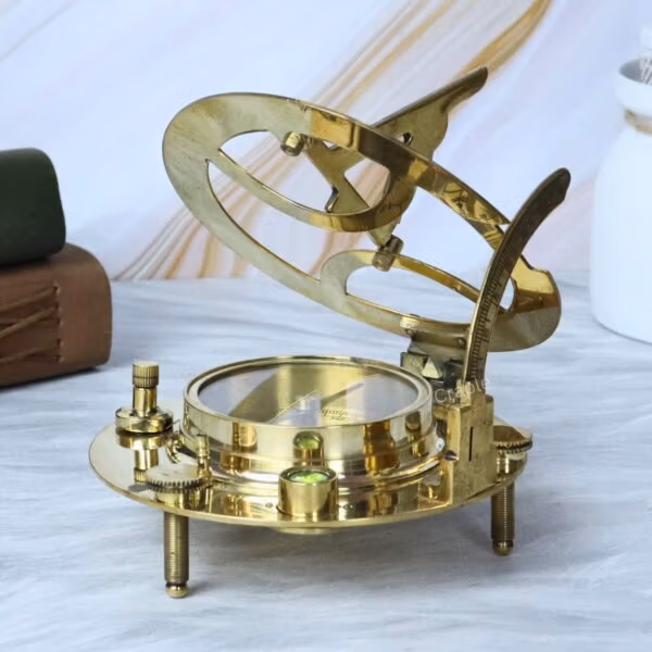 The adjustable brass sundial in an open position, showing a close-up of the integrated liquid-damped magnetic compass.