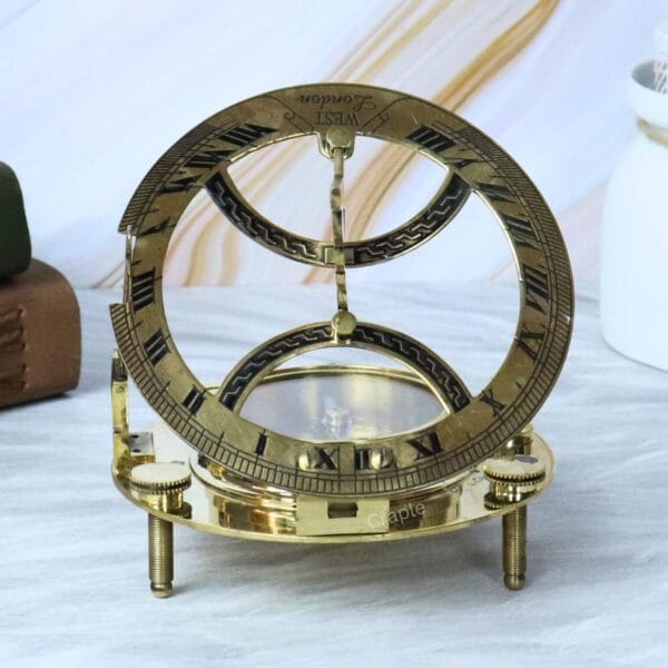 Back view of the open brass sundial, highlighting the full circular hour ring and the adjustable legs.