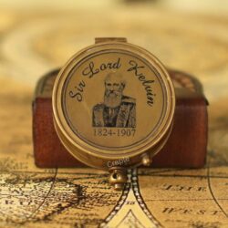 The top lid of a vintage brass pocket sundial compass featuring an engraving of Sir Lord Kelvin.