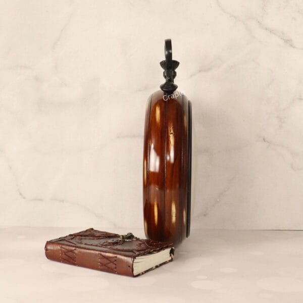 Side profile of the large wooden wall clock, highlighting its deep body and glossy brown finish.