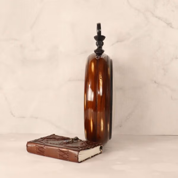 Side profile of the large wooden wall clock, highlighting its deep body and glossy brown finish.