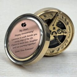 Engraved "Happy Anniversary" brass sundial compass, open to display the romantic message and the vintage-style sundial.