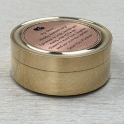 Closed brass pocket compass with a brushed finish, featuring a "Happy Anniversary" message engraved on the lid.