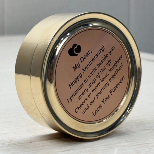 Angled view of the engraved anniversary gift compass, showing the shiny brass casing and the romantic message.