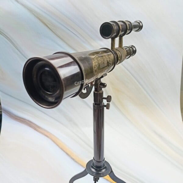 Angled view of the antique-style brass telescope, showcasing the main scope and the smaller finder scope.
