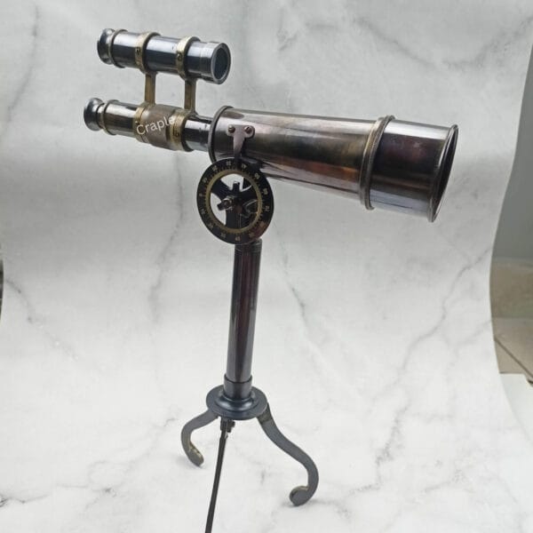 The Kelvin & Hughes decorative telescope tilted upwards on its fully adjustable tripod stand.