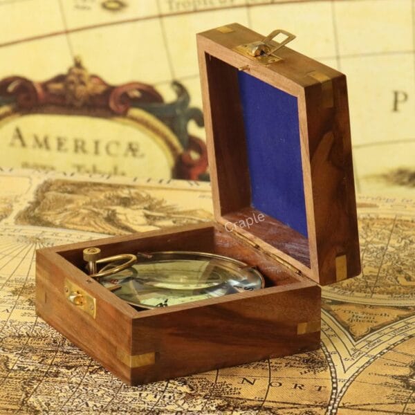 The Spencer & Co. brass compass nestled inside its protective, blue felt-lined sheesham wood box.