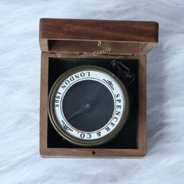 The antique brass Spencer map reader compass presented inside its felt-lined wooden storage and display box.