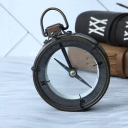 The antique map reader showing its functional internal compass with a jeweled needle and cardinal points.