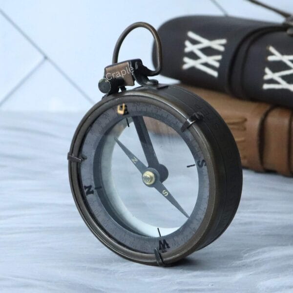 Angled view of the compass inside the Spencer map reader, with the magnifying lens lifted.