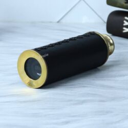 Compact leather-wrapped pocket telescope in its collapsed state, showing the shiny brass objective lens rim.