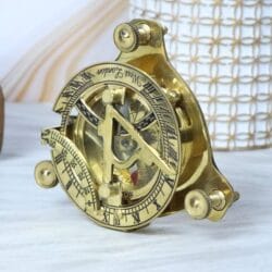 Close-up angled view of a vintage brass navigational sundial compass.