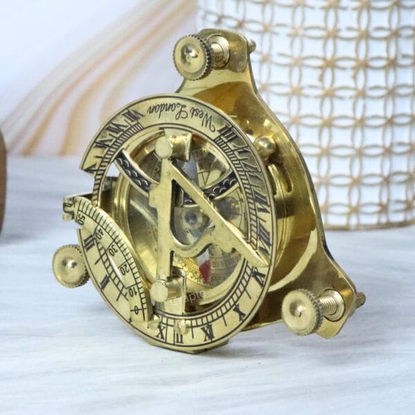 Close-up angled view of a vintage brass navigational sundial compass.