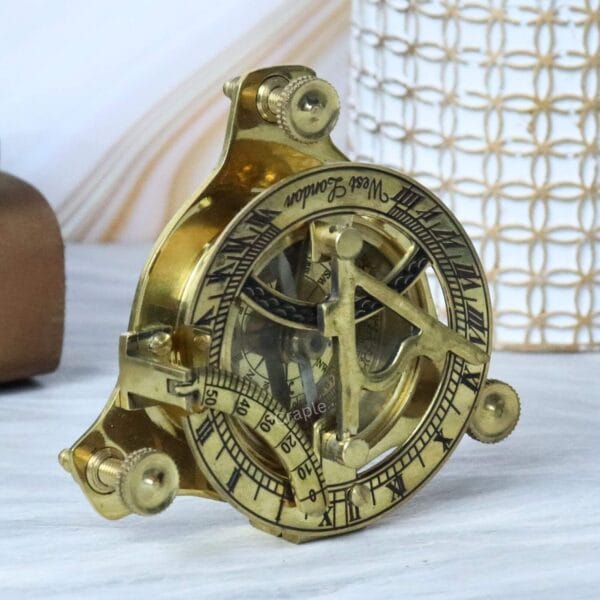Side profile of the West London brass sundial compass demonstrating its compact and intricate construction.