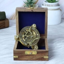 The brass sundial compass nestled inside its felt-lined wooden gift and storage box.