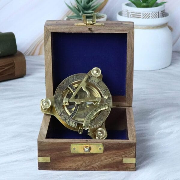 The brass sundial compass nestled inside its felt-lined wooden gift and storage box.
