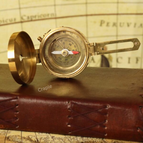 Pocket Size Brass Nautical Brunton Compass-4 An open, vintage-style brass Brunton compass with its sighting arm extended, showing the detailed navigational dial.