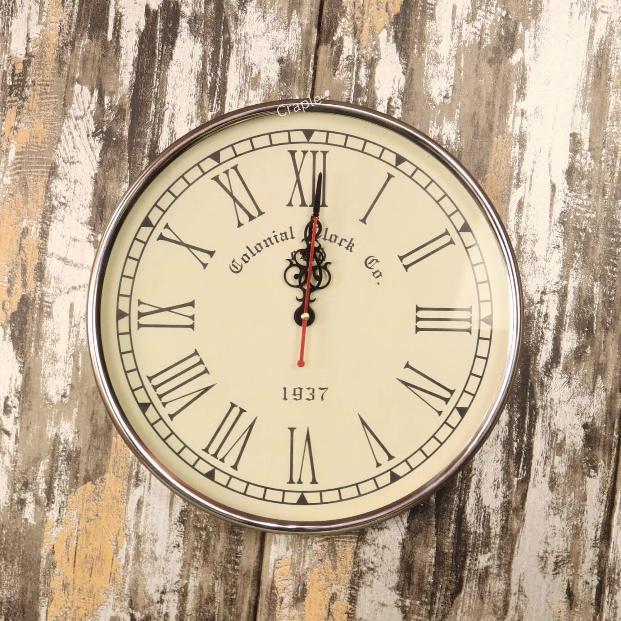 Roman Numeral Silver Steel Wall Clock-1 Vintage-style wall clock with a polished silver steel frame, a cream face, and black Roman numerals.