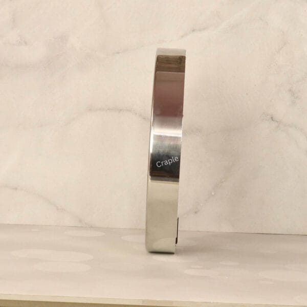 Roman Numeral Silver Steel Wall Clock-3 Side profile of the industrial-style steel wall clock, showing the depth and reflective silver polish finish.