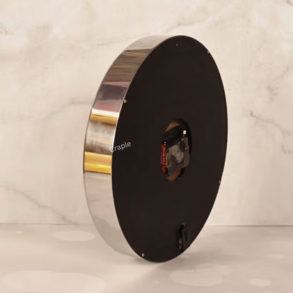The back of the silver steel wall clock, showing the quartz movement mechanism and battery compartment.