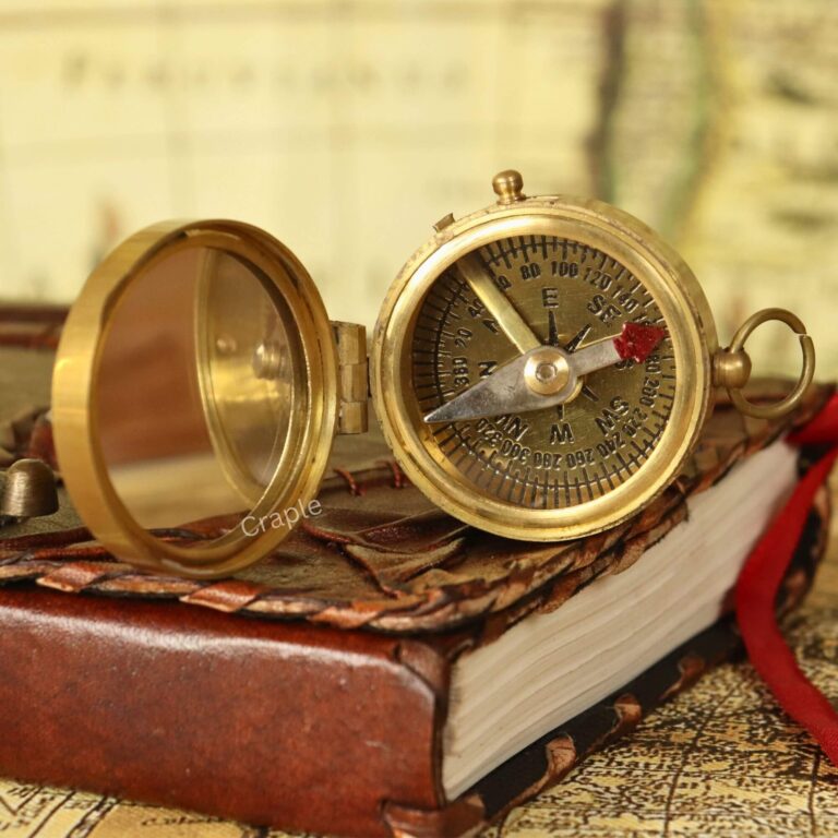 Vintage-style brass pocket compass with an integrated mirror in the lid, opened to show the detailed compass face.