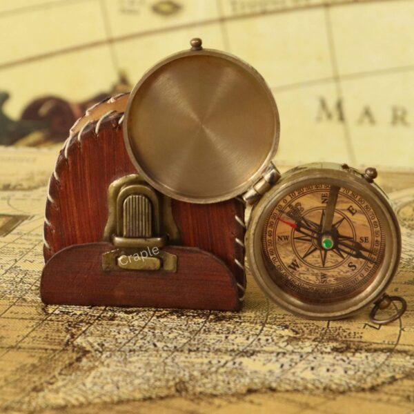 Small Antique Brass Pocket Compass-4 Antique brass pocket compass with its lid open, displayed next to its rustic, hand-stitched leather-style pouch.