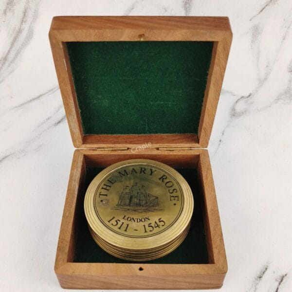 "The Mary Rose" brass sundial compass nestled inside its green felt-lined wooden presentation box.