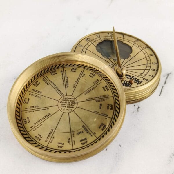 Angled view of the open "Mary Rose" sundial compass, showing its solid brass construction.