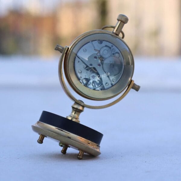 Tilting Orb Shiny Brass Desk Clock-3 Back view of the tilting desk clock showcasing the intricate see-through skeleton gear mechanism.