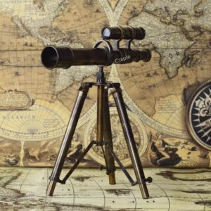 Antique double-barrel brass telescope with a top-mounted finder scope, standing on a vintage wooden and brass tripod.