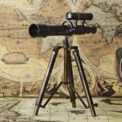 Three-quarter view of the vintage brass and wood tabletop telescope and its foldable tripod.